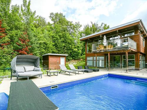 Exterior - 52  - 52A Rue Du Lac-Walfred N., Sainte-Marguerite-Du-Lac-Masson, QC - Outdoor With In Ground Pool