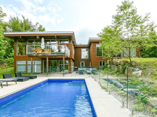 Exterior - 52  - 52A Rue Du Lac-Walfred N., Sainte-Marguerite-Du-Lac-Masson, QC - Outdoor With In Ground Pool