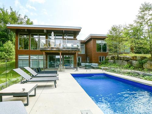 Exterior - 52  - 52A Rue Du Lac-Walfred N., Sainte-Marguerite-Du-Lac-Masson, QC - Outdoor With In Ground Pool