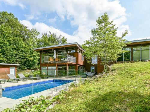 Exterior - 52  - 52A Rue Du Lac-Walfred N., Sainte-Marguerite-Du-Lac-Masson, QC - Outdoor With In Ground Pool