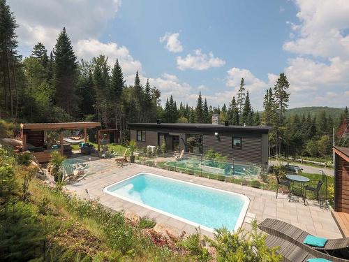 Back facade - 3010 Imp. Des Promeneurs, Sainte-Agathe-Des-Monts, QC - Outdoor With In Ground Pool