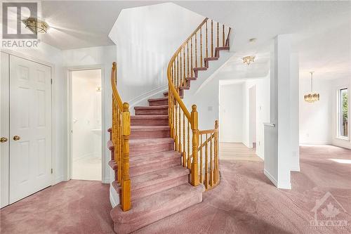 Gorgeous curved staircase to second level, Garage entrance, Laundry room and 2pcs bath to the left. - 34 Stonemeadow Drive, Ottawa, ON - Indoor Photo Showing Other Room