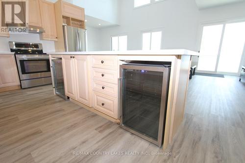 130 Baker Boulevard, Kawartha Lakes, ON - Indoor Photo Showing Kitchen With Fireplace