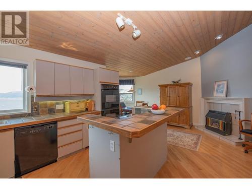 8816 Michael Drive, Coldstream, BC - Indoor Photo Showing Kitchen With Fireplace