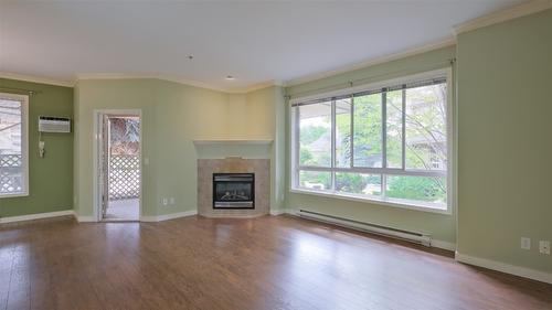 108-1962 Enterprise Way, Kelowna, BC - Indoor Photo Showing Living Room With Fireplace