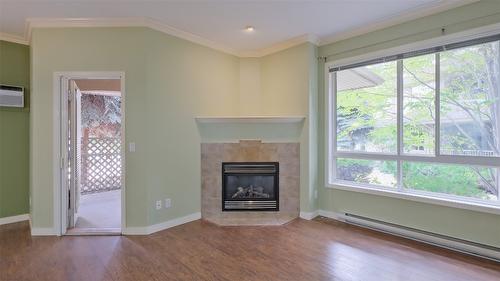 108-1962 Enterprise Way, Kelowna, BC - Indoor Photo Showing Living Room With Fireplace