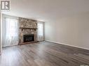 2843 Kutarna Crescent E, Regina, SK  - Indoor Photo Showing Living Room With Fireplace 