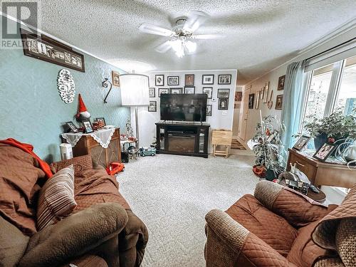 21 208 Eighth Street, 100 Mile House, BC - Indoor Photo Showing Living Room With Fireplace