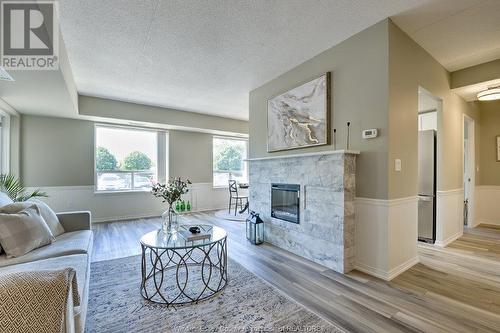 8275 Wyandotte Street East Unit# 107, Windsor, ON - Indoor Photo Showing Living Room With Fireplace