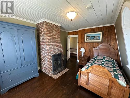 4 Dandy Lane, Trinity, NL - Indoor Photo Showing Bedroom With Fireplace