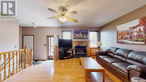 7155 Bright Bay, Regina, SK - Indoor Photo Showing Living Room With Fireplace