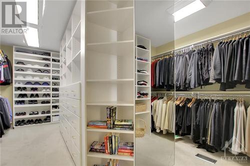 Primary double-sided walk-in closet - 105 Locharron Crescent, Ottawa, ON - Indoor With Storage