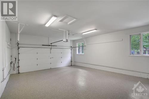 New garage floor and just painted walls - 105 Locharron Crescent, Ottawa, ON - Indoor Photo Showing Garage