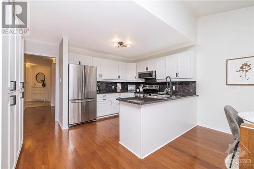 Lovely kitchen features stainless steel appliances, granite countertops, and ample cabinet space. - 1454 Shawinigan Street, Ottawa, ON - Indoor Photo Showing Kitchen