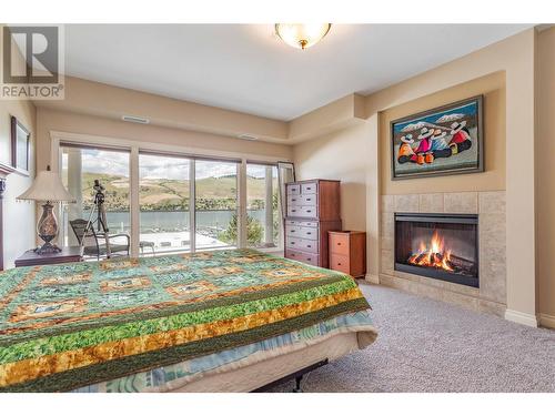 7922 Okanagan Landing Road Unit# 404, Vernon, BC - Indoor Photo Showing Bedroom With Fireplace
