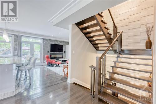 Stunning glass staircase with accent wall from top  to bottom - 577 Foxview Place, Ottawa, ON - Indoor Photo Showing Other Room