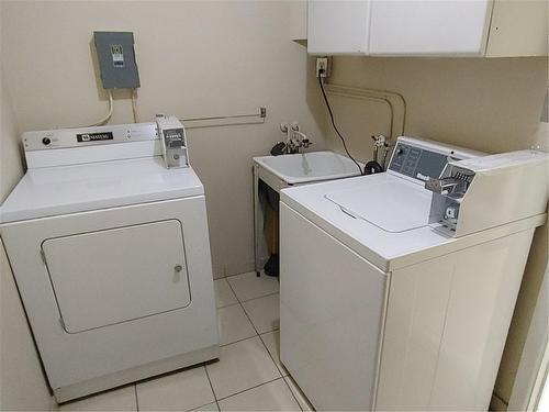 Shared coin operated laundry - 334 Upper Ottawa Street|Unit #Apt. 1, Hamilton, ON - Indoor Photo Showing Laundry Room
