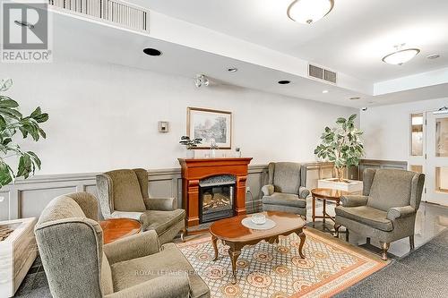 411 - 2199 Sixth Line, Oakville (River Oaks), ON - Indoor Photo Showing Living Room With Fireplace