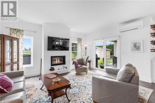 View to the field and access to back yard - 3630 Pattee Road, Hawkesbury, ON - Indoor Photo Showing Living Room With Fireplace