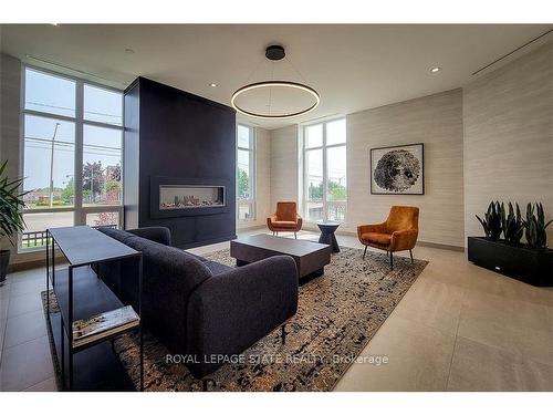 515-2750 King St E, Hamilton, ON - Indoor Photo Showing Living Room With Fireplace