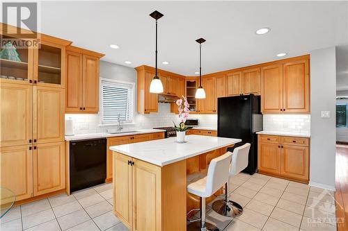 Tall maple cabinets, large island, quartz countertop (updated 2023), double sink, LG stove updated 2022 - 31 Forillon Crescent, Ottawa, ON - Indoor Photo Showing Kitchen