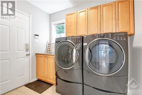 Laundry on the main floor with sink, cabinets and large walk-in closet near the entrance to the garage - 31 Forillon Crescent, Ottawa, ON - Indoor Photo Showing Laundry Room