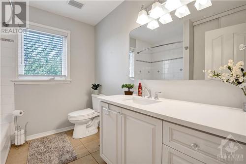 Bathroom #2 with the bath/shower, quartz counter top and a huge storage closet with shelves - 31 Forillon Crescent, Ottawa, ON - Indoor Photo Showing Bathroom