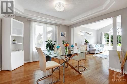 Beautiful dining area with tray ceiling and sparkling chandelier - 31 Forillon Crescent, Ottawa, ON - Indoor Photo Showing Dining Room