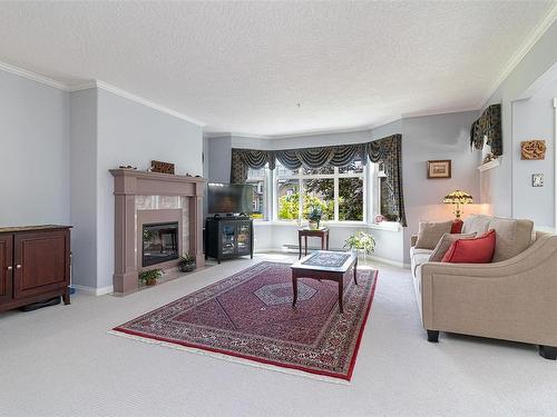 256-4488 Chatterton Way, Saanich, BC - Indoor Photo Showing Living Room With Fireplace