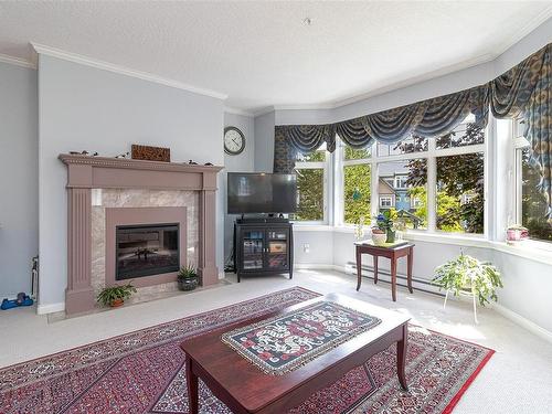 256-4488 Chatterton Way, Saanich, BC - Indoor Photo Showing Living Room With Fireplace