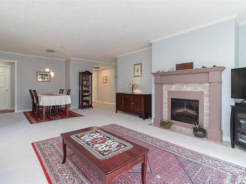 256-4488 Chatterton Way, Saanich, BC - Indoor Photo Showing Living Room With Fireplace