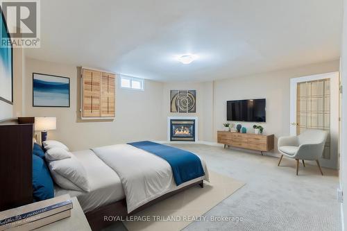 Lower fam room,shown used as bedroom by prev owner - 4 - 5 River Road, Lambton Shores (Grand Bend), ON - Indoor Photo Showing Bedroom With Fireplace