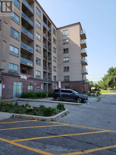 212 - 7405 Goreway Drive W, Mississauga (Malton), ON - Outdoor With Balcony With Facade