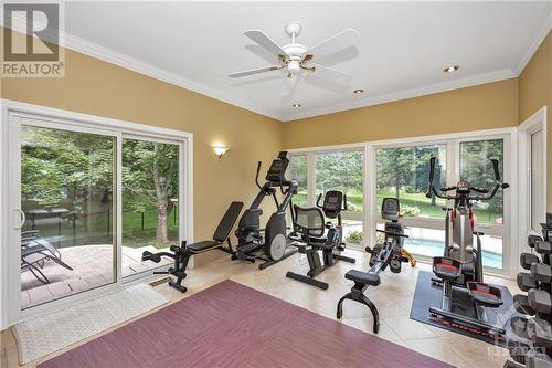 Early morning workouts, or if you're an artist, turn this area into an art studio. Beautiful views to the pool and step out onto the side patio. - 105 Locharron Crescent, Ottawa, ON - Indoor Photo Showing Gym Room