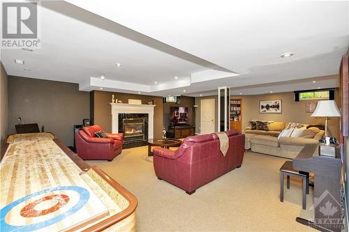 Lower level recreation area with shuffleboard, pool table, fireplace and wet bar. - 105 Locharron Crescent, Ottawa, ON - Indoor With Fireplace