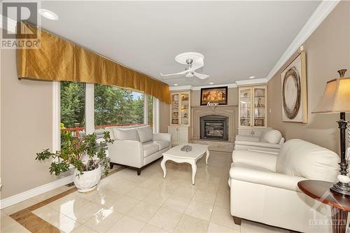 Cozy family room with gas fireplace - 105 Locharron Crescent, Ottawa, ON - Indoor Photo Showing Living Room With Fireplace