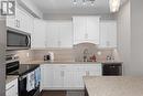 1165 Sutherland Avenue Unit# 410, Kelowna, BC  - Indoor Photo Showing Kitchen With Stainless Steel Kitchen With Double Sink With Upgraded Kitchen 