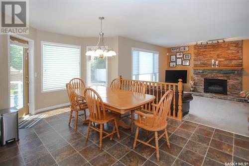 206 Braeshire Lane, Saskatoon, SK - Indoor Photo Showing Dining Room With Fireplace