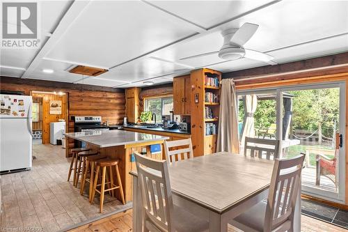 Open concept kitchen and dining room with access to the back deck - 579 Cape Hurd Road, Tobermory, ON - Indoor Photo Showing Dining Room