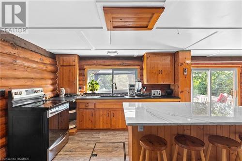 Plenty of cabinets on both sides for storage. New granite on counters and island - 579 Cape Hurd Road, Tobermory, ON - Indoor Photo Showing Kitchen