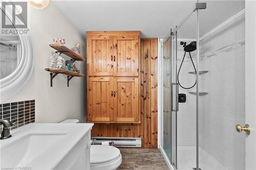 This is the second bathroom. Updates include porcelain floor, granite and backsplash on vanity and large walk in shower - 579 Cape Hurd Road, Tobermory, ON - Indoor Photo Showing Bathroom