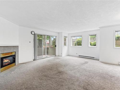 101-1714 Fort St, Victoria, BC - Indoor Photo Showing Living Room With Fireplace