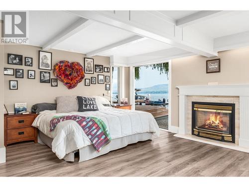 8180 Tronson Road, Vernon, BC - Indoor Photo Showing Bedroom With Fireplace