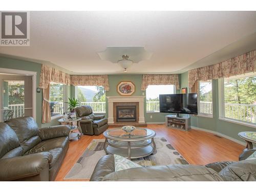 7775 Chew Road, Vernon, BC - Indoor Photo Showing Living Room With Fireplace