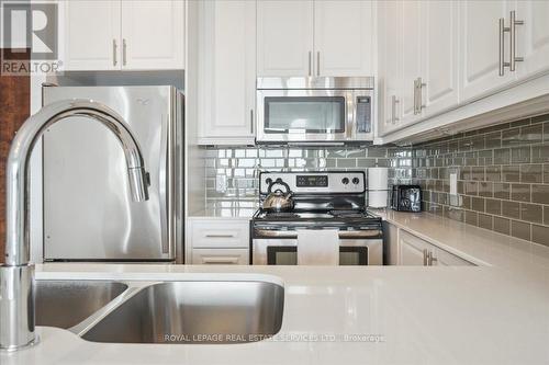 407 - 2480 Prince Michael Drive, Oakville (Iroquois Ridge North), ON - Indoor Photo Showing Kitchen With Stainless Steel Kitchen With Double Sink With Upgraded Kitchen