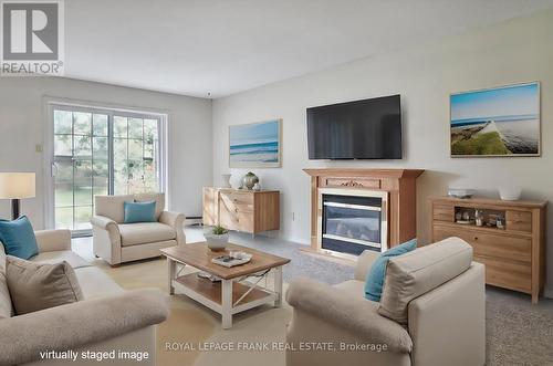 10 - 635 Whitaker Street, Peterborough (Ashburnham), ON - Indoor Photo Showing Living Room With Fireplace