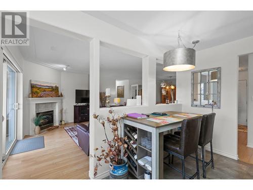 1895 Ambrosi Road Unit# 406, Kelowna, BC - Indoor Photo Showing Dining Room With Fireplace