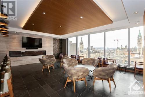 Sky lounge with view of Parliament - 101 Queen Street Unit#803, Ottawa, ON - Indoor Photo Showing Living Room With Fireplace