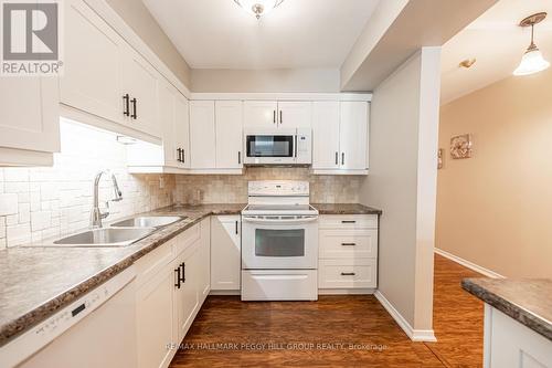 212 - 10 Coulter Street, Barrie (Sunnidale), ON - Indoor Photo Showing Kitchen With Double Sink