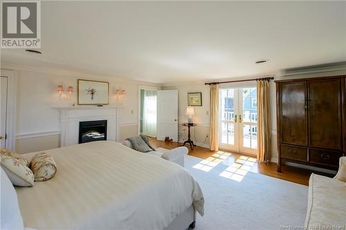 235 Queen Street, Saint Andrews, NB - Indoor Photo Showing Bedroom With Fireplace